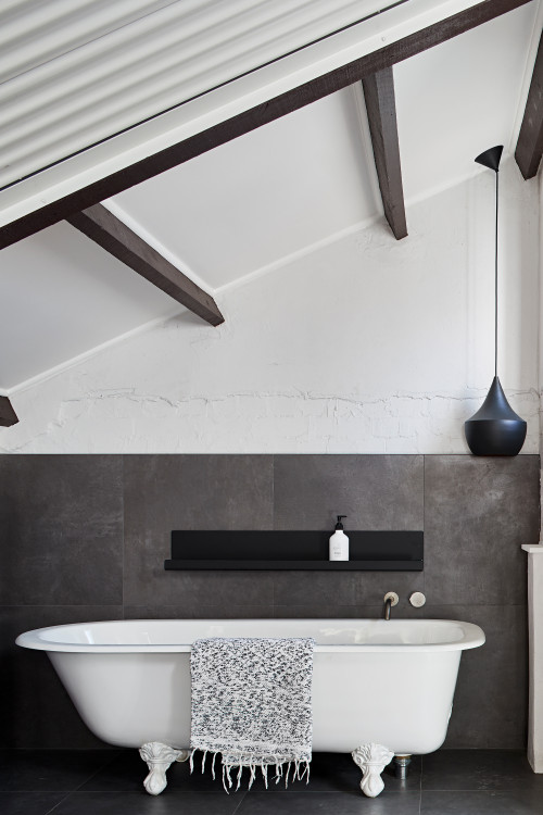 Rustic Fusion: Gray White Bathroom with a Clawfoot Tub and Exposed Beams