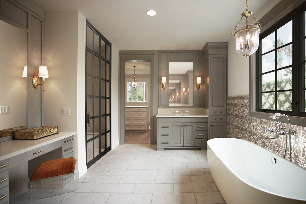 Inspiration for a large transitional master gray tile and terra-cotta tile terra-cotta tile, white floor and double-sink bathroom remodel in Phoenix with recessed-panel cabinets, gray cabinets, white walls, an undermount sink, quartz countertops, a hinged shower door, beige countertops and a built-in vanity