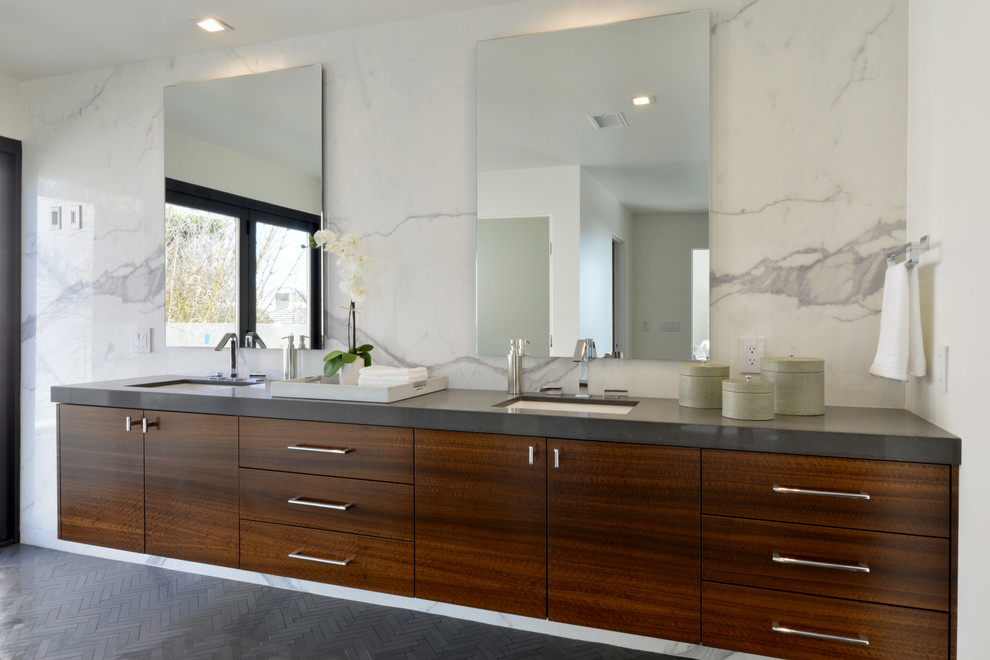 Photo of an expansive modern ensuite bathroom in San Diego with flat-panel cabinets, medium wood cabinets, a freestanding bath, a shower/bath combination, white tiles, stone tiles, white walls, marble flooring, a submerged sink and engineered stone worktops.