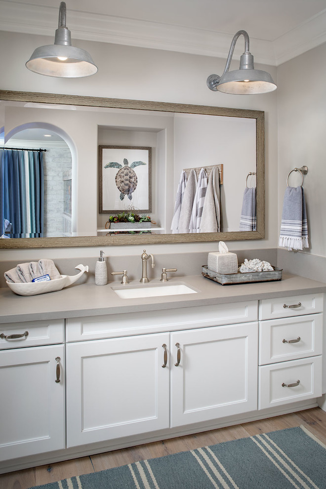 This is an example of a medium sized farmhouse family bathroom in San Diego with grey walls, light hardwood flooring and a built-in sink.