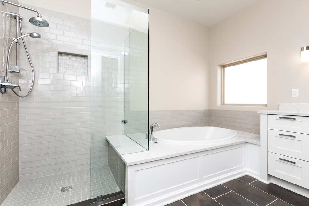 Example of a mid-sized transitional master gray tile and porcelain tile slate floor and gray floor bathroom design in Albuquerque with shaker cabinets, white cabinets, a one-piece toilet, beige walls, an undermount sink, quartz countertops and a hinged shower door