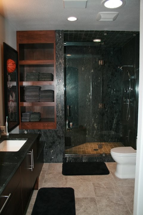 Example of a huge minimalist gray tile and marble tile porcelain tile and beige floor doorless shower design in San Diego with flat-panel cabinets, dark wood cabinets, a two-piece toilet, white walls, an undermount sink, soapstone countertops, a hinged shower door and gray countertops