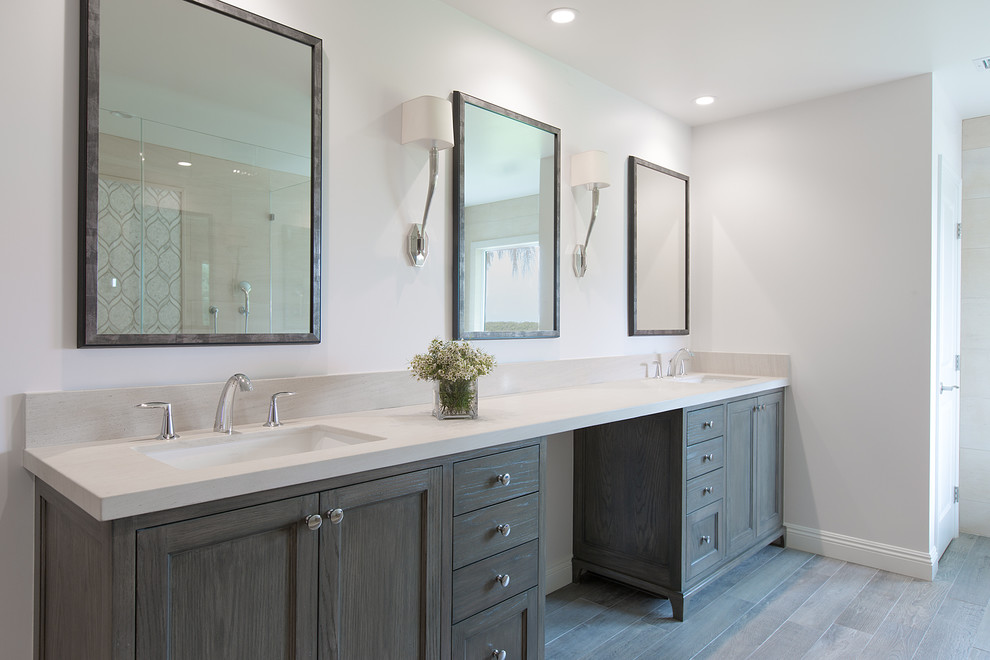 Mid-sized transitional master mosaic tile medium tone wood floor bathroom photo in Los Angeles with dark wood cabinets, an undermount sink, limestone countertops, shaker cabinets and white walls