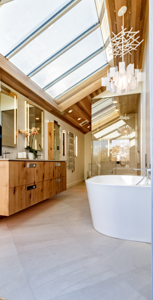 Inspiration for a large contemporary ensuite bathroom in Vancouver with flat-panel cabinets, medium wood cabinets, a freestanding bath, a double shower, a one-piece toilet, grey tiles, cement tiles, white walls, concrete flooring, a submerged sink, concrete worktops, grey floors, a hinged door and grey worktops.