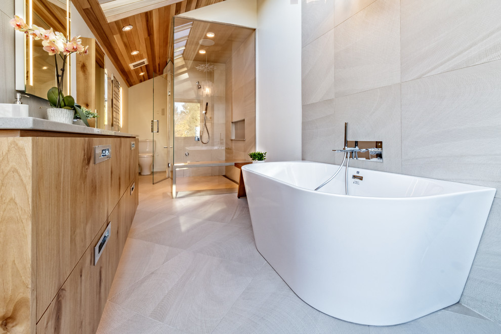 Large trendy master gray tile and cement tile concrete floor and gray floor bathroom photo in Vancouver with flat-panel cabinets, medium tone wood cabinets, a one-piece toilet, white walls, an undermount sink, concrete countertops, a hinged shower door and gray countertops