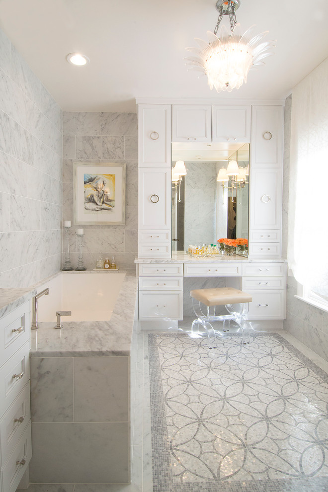 Classic bathroom in Austin with recessed-panel cabinets, white cabinets, a submerged bath, grey tiles, mosaic tiles and mosaic tile flooring.