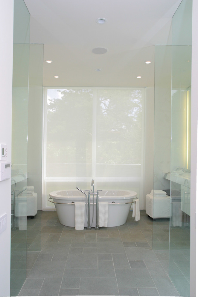 Пример оригинального дизайна: большая главная ванная комната в современном стиле с плоскими фасадами, белыми фасадами, отдельно стоящей ванной, угловым душем, серой плиткой, белой плиткой, каменной плиткой, белыми стенами, полом из цементной плитки, врезной раковиной и мраморной столешницей