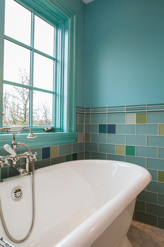 This is an example of a medium sized classic family bathroom in Boston with a freestanding bath, multi-coloured tiles, glass tiles and blue walls.