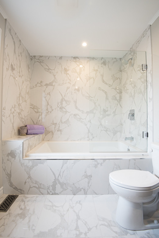 Inspiration for a medium sized traditional ensuite bathroom in Toronto with dark wood cabinets, an alcove bath, a shower/bath combination, a one-piece toilet, porcelain tiles, grey walls, porcelain flooring and quartz worktops.