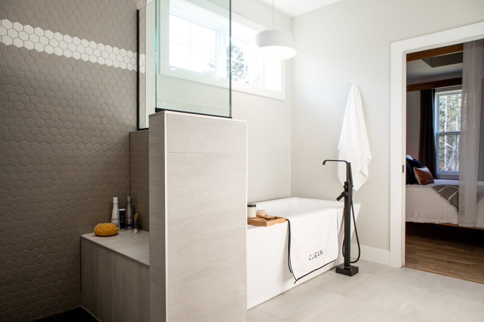Bathroom - large scandinavian master gray tile and ceramic tile ceramic tile and gray floor bathroom idea in Other with flat-panel cabinets, light wood cabinets, gray walls, a vessel sink, solid surface countertops and white countertops