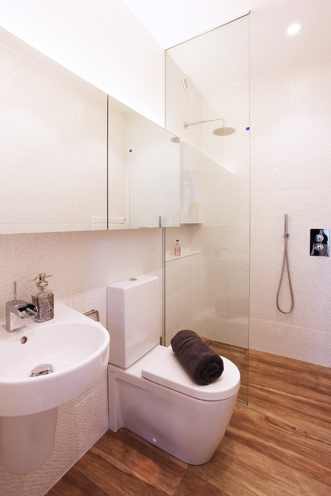 На фото: главная ванная комната среднего размера в современном стиле с открытым душем, унитазом-моноблоком, белыми стенами и светлым паркетным полом