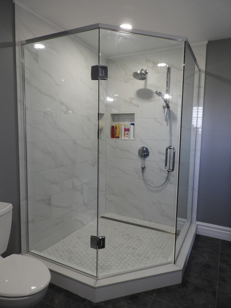 Inspiration for a small contemporary master white tile and marble tile vinyl floor and gray floor bathroom remodel in Toronto with shaker cabinets, gray cabinets, a two-piece toilet, gray walls, an undermount sink, granite countertops, a hinged shower door and gray countertops