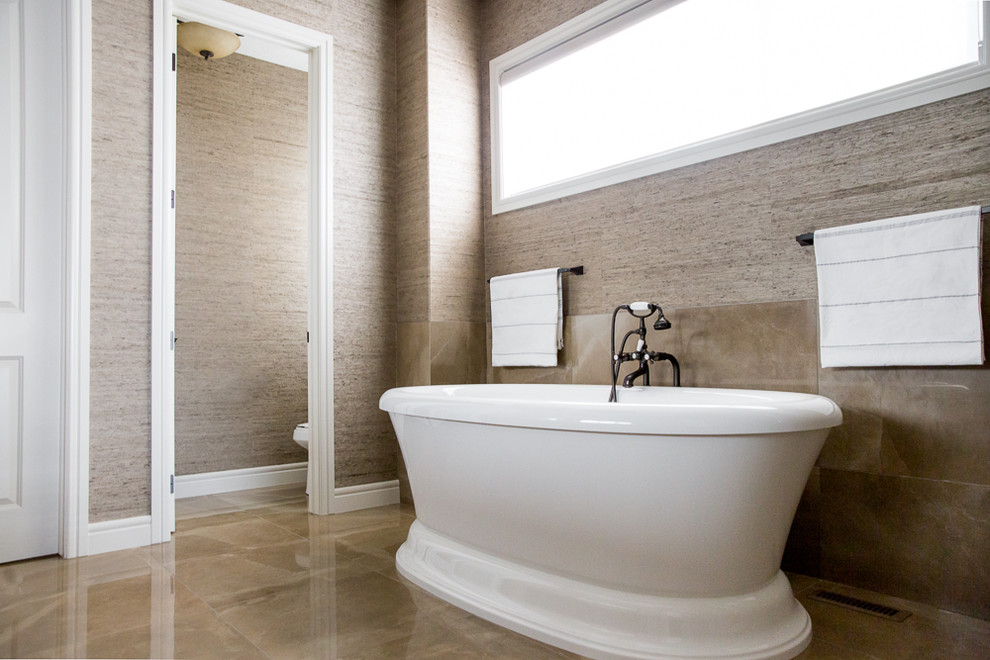 Inspiration for a large classic ensuite bathroom in Vancouver with shaker cabinets, dark wood cabinets, a freestanding bath, an alcove shower, brown walls, a submerged sink, marble worktops, brown floors and a hinged door.
