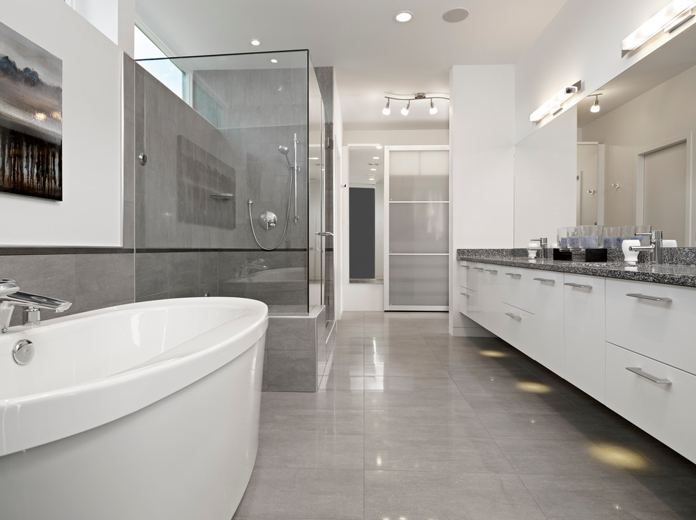 Photo of a modern grey and white bathroom in Edmonton with a freestanding bath.