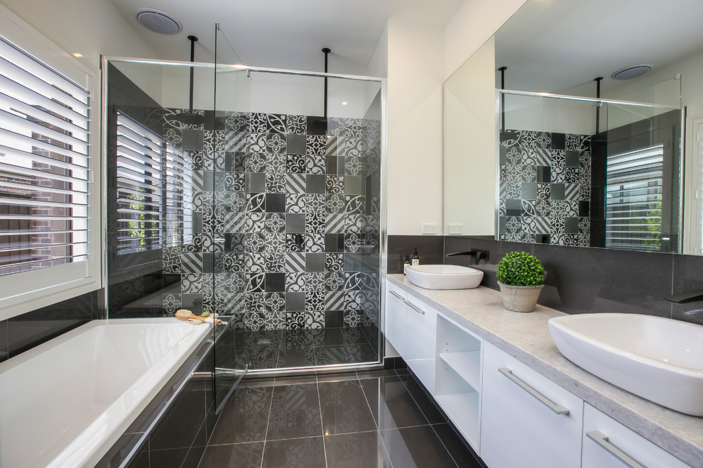 Inspiration for a large contemporary ensuite bathroom in Melbourne with flat-panel cabinets, white cabinets, a built-in bath, grey tiles, white walls, a vessel sink, ceramic tiles, engineered stone worktops, an alcove shower and grey worktops.