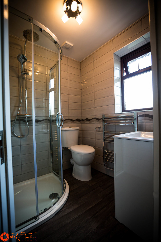 Cette photo montre une petite salle de bain principale tendance avec une douche d'angle, WC séparés, un carrelage gris, des carreaux de céramique, un mur gris, un sol en vinyl et un plan vasque.