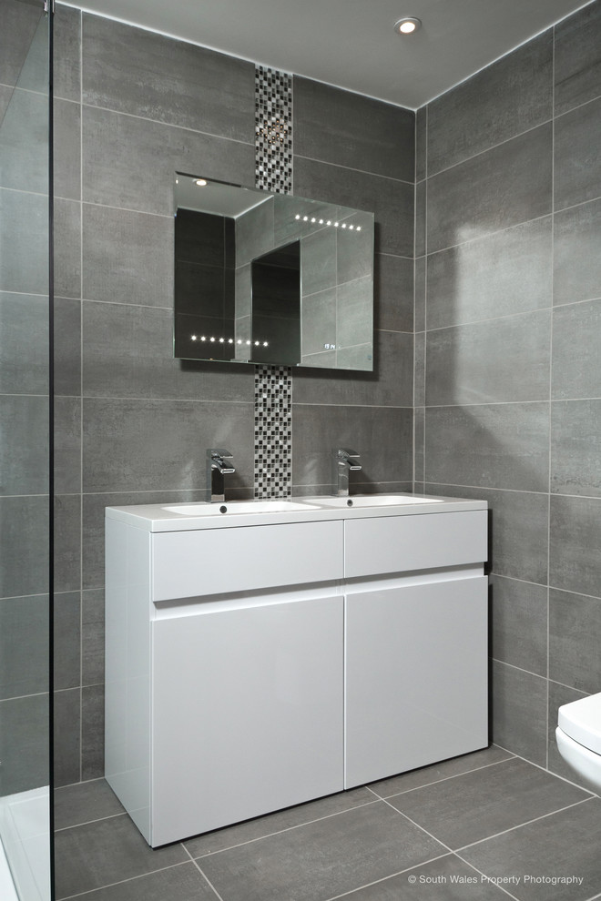 Стильный дизайн: маленькая главная ванная комната в современном стиле с плоскими фасадами, белыми фасадами и серой плиткой для на участке и в саду - последний тренд