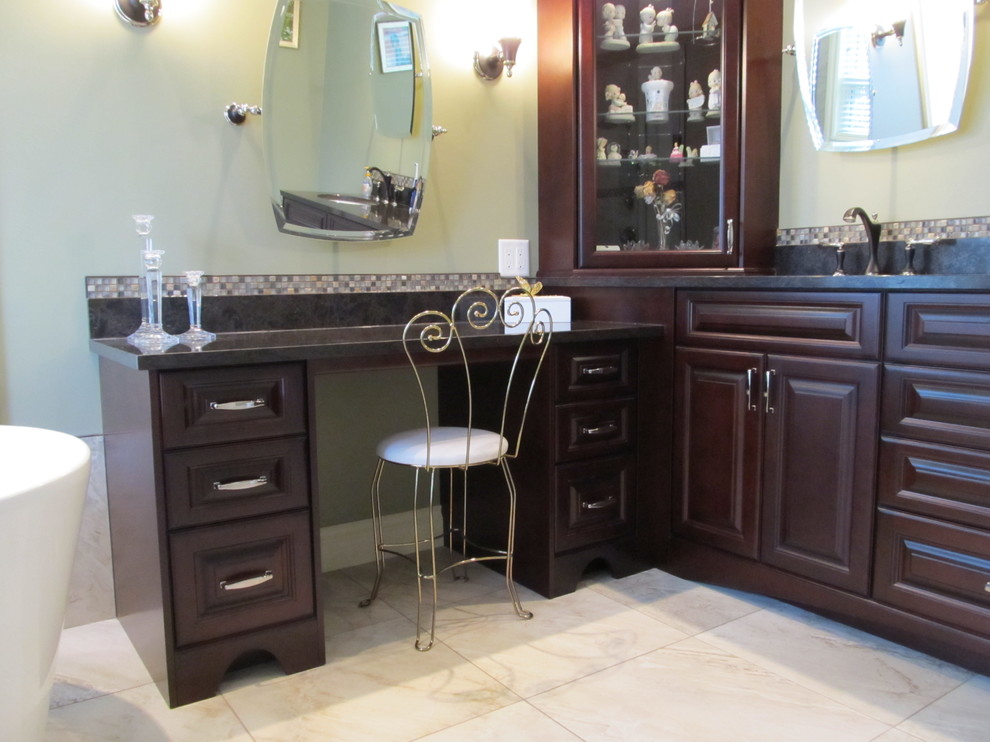 Traditional ensuite bathroom in Vancouver with a submerged sink, raised-panel cabinets, dark wood cabinets, engineered stone worktops, a freestanding bath, a two-piece toilet and mosaic tiles.