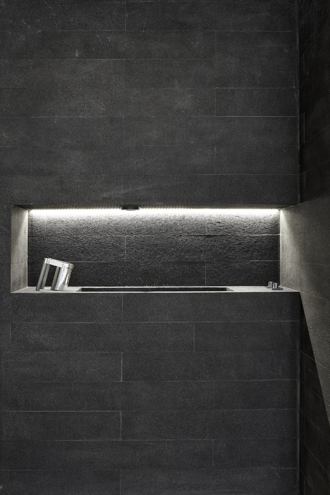 Bathroom - contemporary stone tile bathroom idea in Miami with a trough sink and granite countertops
