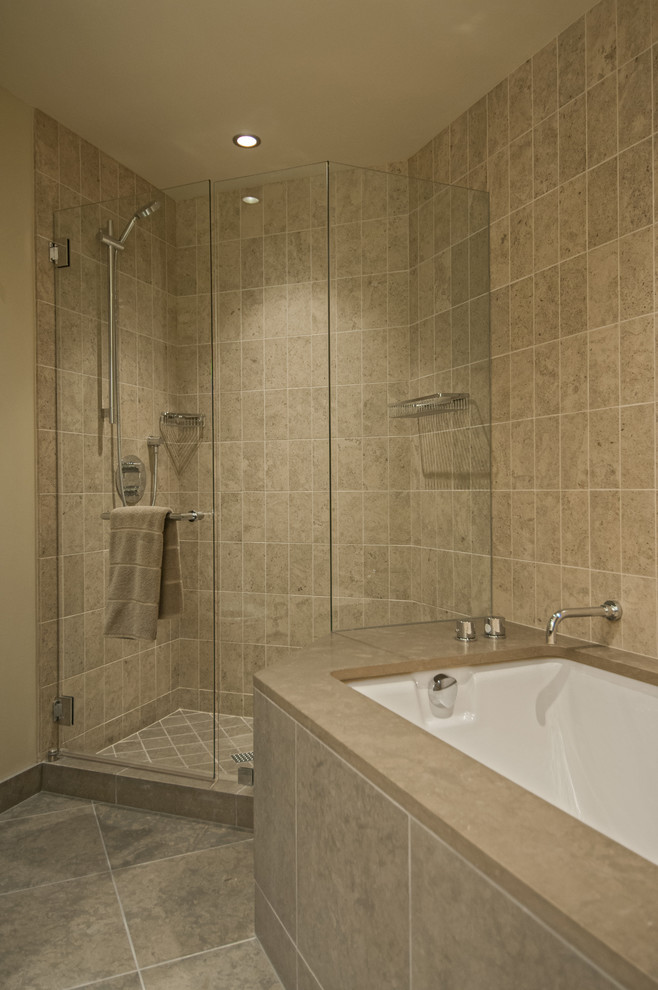 Bathroom - large contemporary master gray tile and stone slab limestone floor and gray floor bathroom idea in Seattle with flat-panel cabinets, white walls, an undermount sink, solid surface countertops, a hinged shower door, medium tone wood cabinets and a bidet