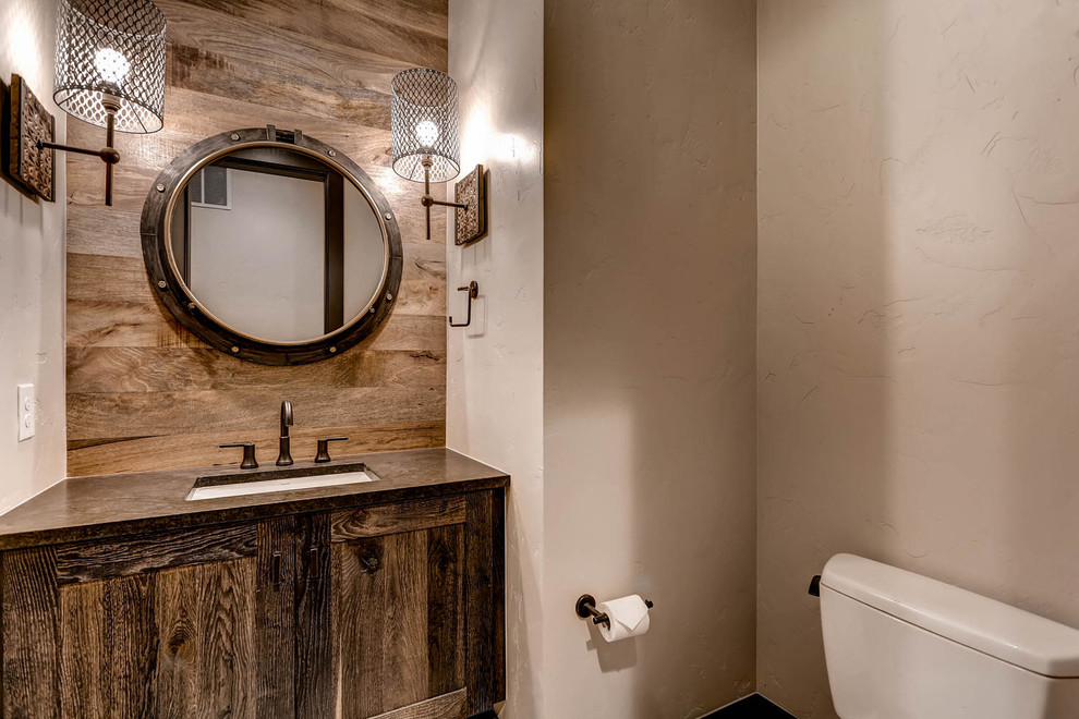 Inspiration for a small rustic medium tone wood floor bathroom remodel in Minneapolis with shaker cabinets, dark wood cabinets, a one-piece toilet, white walls, an undermount sink and quartzite countertops