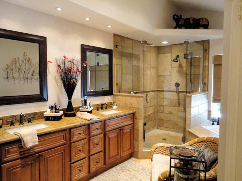 Large elegant master travertine floor and beige floor bathroom photo in San Diego with beaded inset cabinets, medium tone wood cabinets, white walls, an undermount sink, granite countertops, a hinged shower door and multicolored countertops