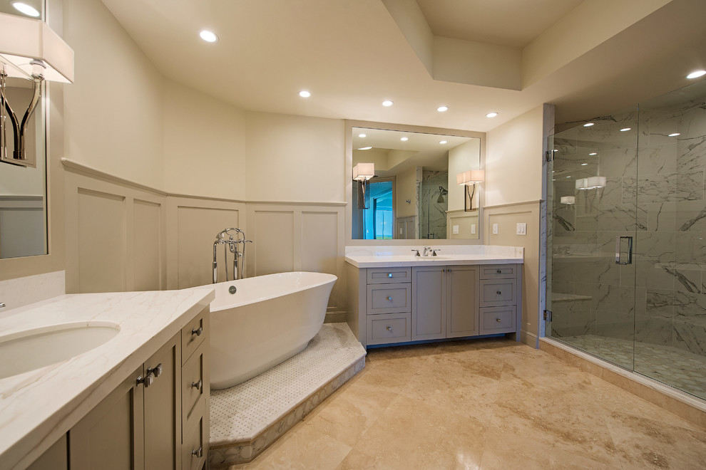 Large classic ensuite bathroom in Miami with shaker cabinets, grey cabinets, a freestanding bath, white tiles, grey tiles, multi-coloured tiles, stone tiles, a submerged sink, marble worktops, beige walls and marble flooring.