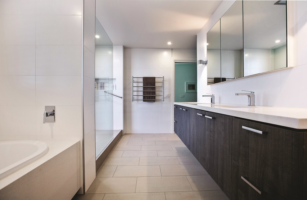 Design ideas for a contemporary ensuite bathroom in Melbourne with engineered stone worktops, flat-panel cabinets, dark wood cabinets, an alcove bath, an alcove shower, white tiles, ceramic tiles, white walls, ceramic flooring, a submerged sink and an open shower.