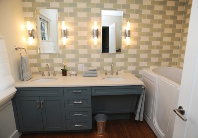 Mittelgroßes Badezimmer mit Unterbauwaschbecken, Kassettenfronten, blauen Schränken, Quarzit-Waschtisch, grauen Fliesen, Keramikfliesen, weißer Wandfarbe und braunem Holzboden in New York
