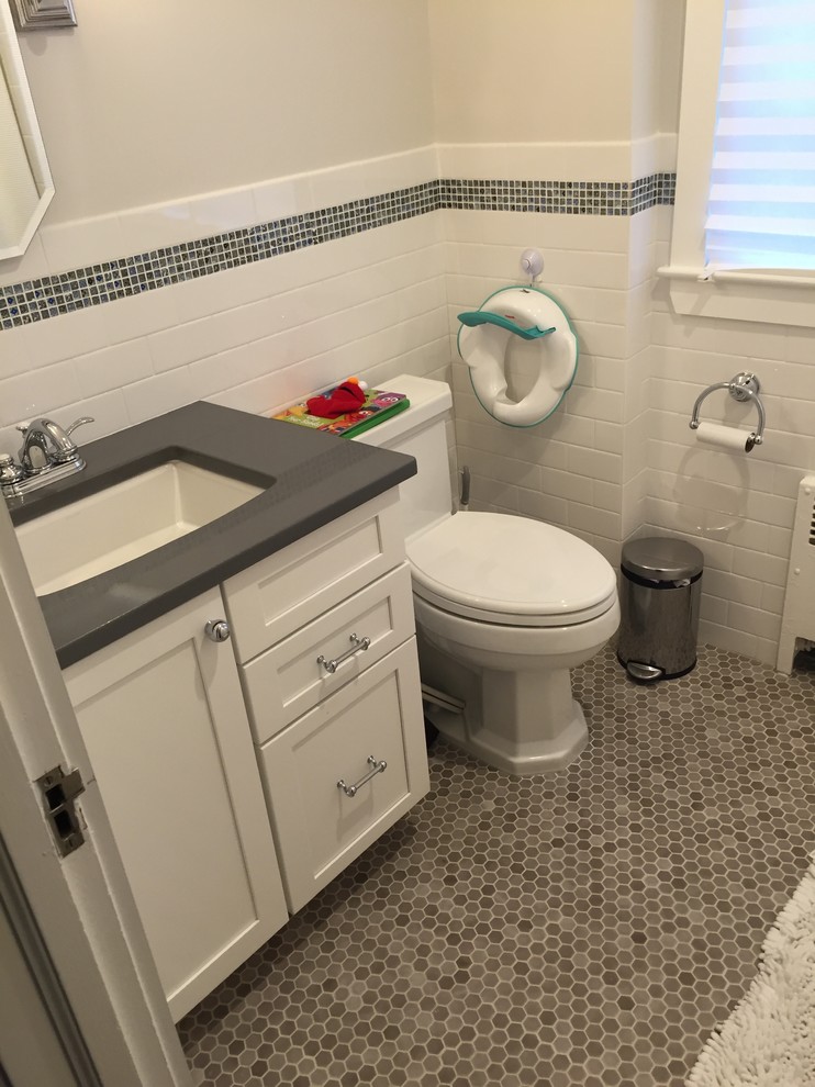 На фото: ванная комната в классическом стиле с белыми фасадами, душем над ванной, белой плиткой, плиткой кабанчик, врезной раковиной, серым полом, шторкой для ванной и серыми стенами с