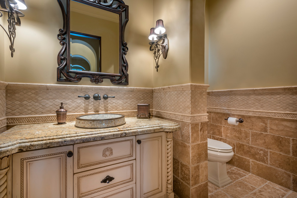 Design ideas for an expansive traditional ensuite bathroom in Phoenix with raised-panel cabinets, medium wood cabinets, a built-in bath, a built-in shower, a two-piece toilet, beige tiles, mosaic tiles, beige walls, travertine flooring, a built-in sink and granite worktops.