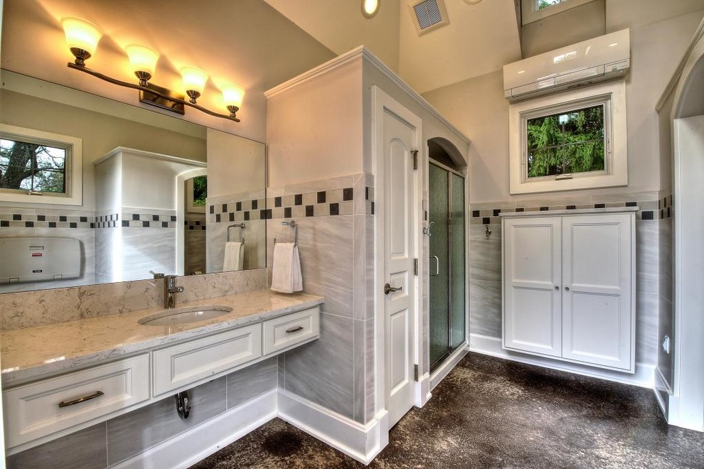 Design ideas for a large traditional bathroom in Indianapolis with shaker cabinets, white cabinets, grey tiles, porcelain tiles, grey walls, concrete flooring, a submerged sink, engineered stone worktops, multi-coloured floors and a hinged door.