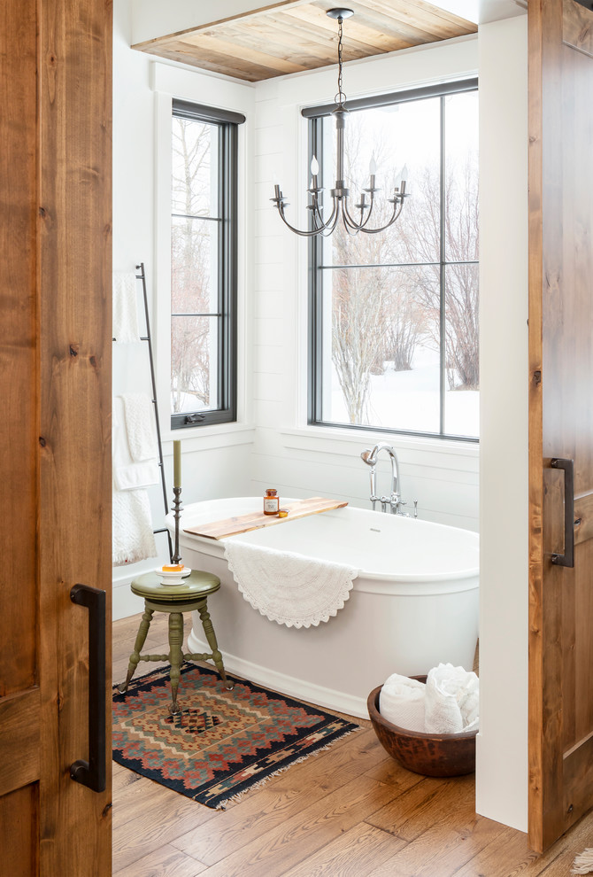 На фото: ванная комната в стиле кантри с белыми стенами, паркетным полом среднего тона и коричневым полом