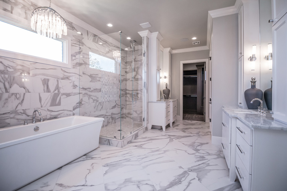 Свежая идея для дизайна: огромная главная ванная комната в стиле неоклассика (современная классика) с плоскими фасадами, белыми фасадами, отдельно стоящей ванной, открытым душем, серой плиткой, белой плиткой, мраморной плиткой, серыми стенами, мраморным полом, врезной раковиной, мраморной столешницей, разноцветным полом, душем с распашными дверями и серой столешницей - отличное фото интерьера