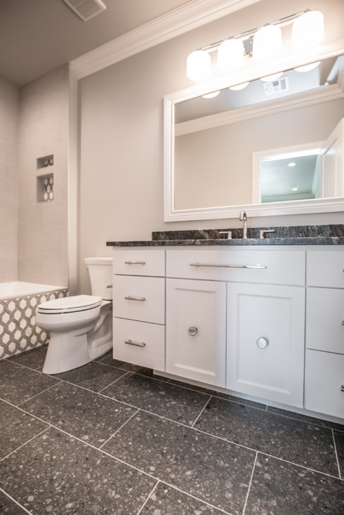 Foto på ett mellanstort vintage svart badrum med dusch, med släta luckor, vita skåp, ett badkar i en alkov, en dusch/badkar-kombination, en toalettstol med separat cisternkåpa, marmorkakel, grå väggar, ett undermonterad handfat, marmorbänkskiva, flerfärgat golv och dusch med duschdraperi