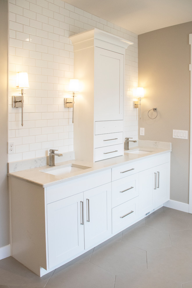 Photo of a large classic ensuite bathroom in Salt Lake City with shaker cabinets, white cabinets, a built-in bath, an alcove shower, white tiles, ceramic tiles, beige walls, ceramic flooring, a submerged sink, engineered stone worktops, beige floors and an open shower.