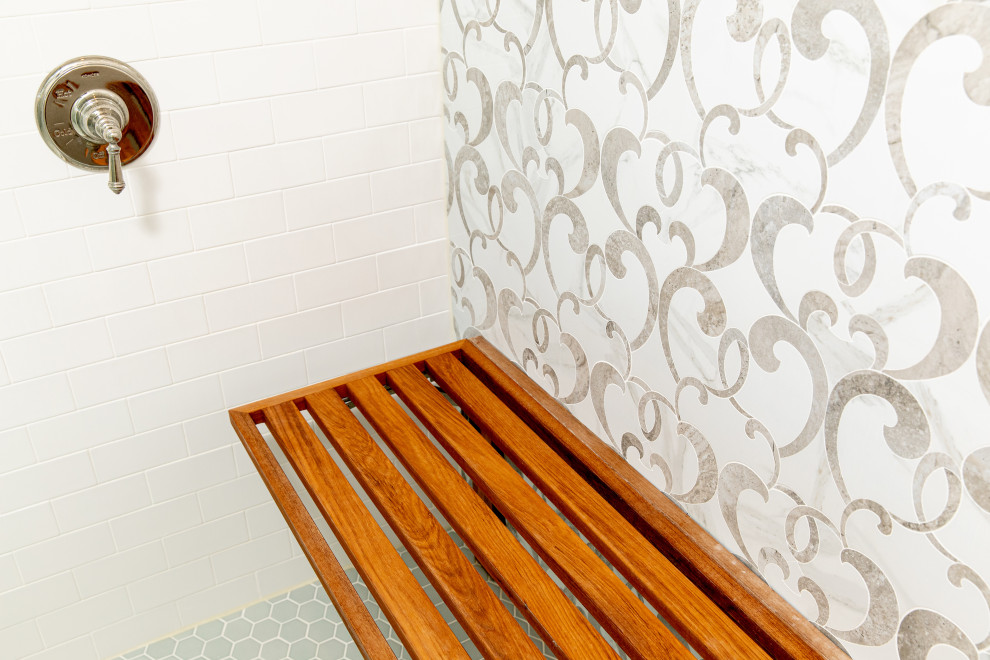 На фото: главная ванная комната в стиле неоклассика (современная классика) с фасадами в стиле шейкер, разноцветной плиткой, душем с распашными дверями, белой столешницей, сиденьем для душа, тумбой под две раковины и встроенной тумбой с