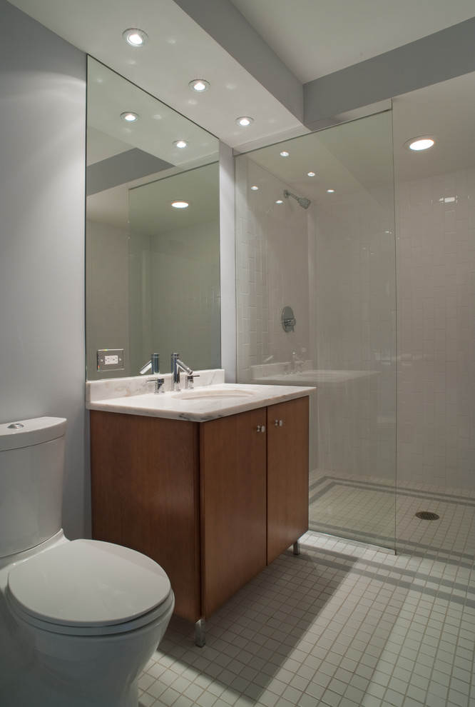 Photo of a medium sized modern shower room bathroom in Chicago with a submerged sink, flat-panel cabinets, light wood cabinets, marble worktops, a walk-in shower, a one-piece toilet, grey tiles, porcelain tiles, grey walls and porcelain flooring.