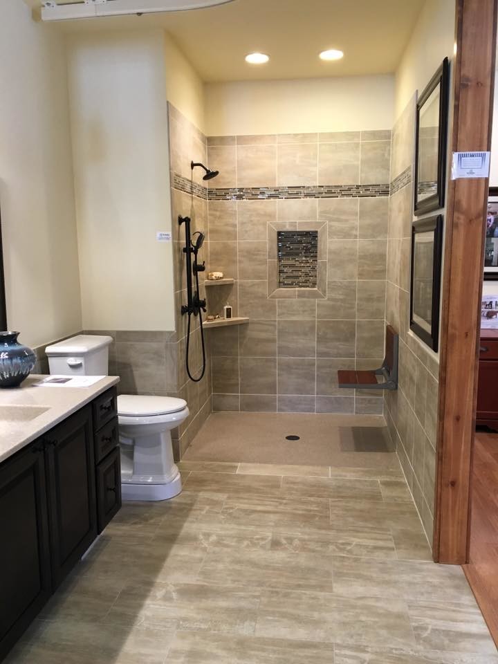 Mid-sized trendy gray tile and porcelain tile porcelain tile and gray floor open shower photo in Denver with recessed-panel cabinets, black cabinets, a two-piece toilet, beige walls, an integrated sink, quartz countertops and gray countertops