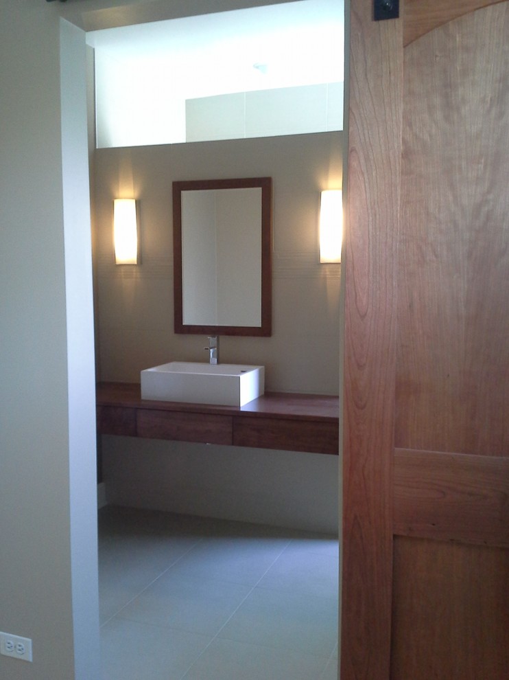 Inspiration for a mid-sized contemporary master ceramic tile ceramic tile bathroom remodel in Chicago with a vessel sink, flat-panel cabinets, dark wood cabinets and wood countertops