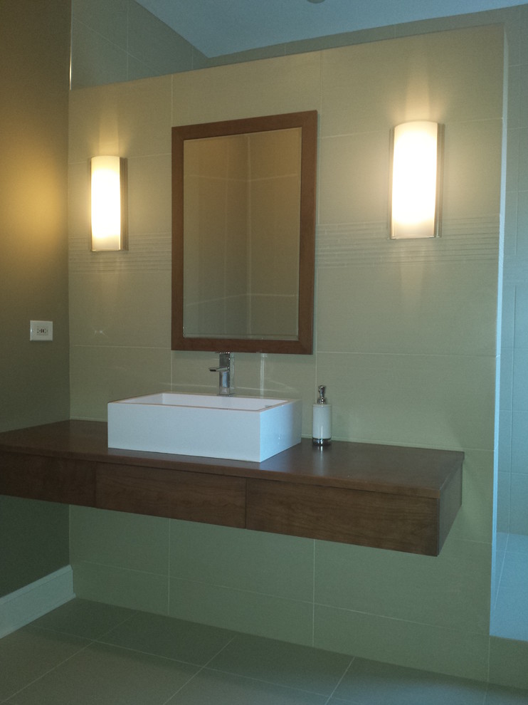 Example of a mid-sized trendy master ceramic tile ceramic tile bathroom design in Chicago with a vessel sink, flat-panel cabinets, dark wood cabinets and wood countertops