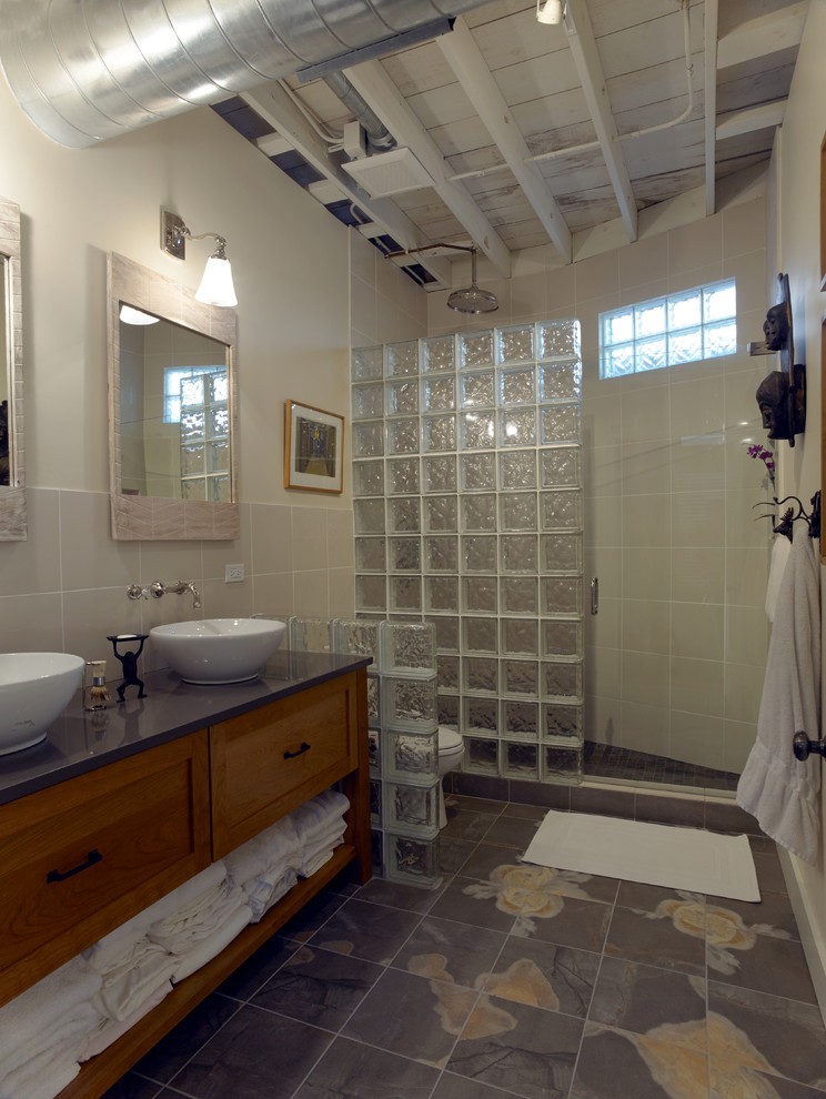 Example of a mid-sized urban master beige tile and stone tile slate floor doorless shower design in Chicago with a vessel sink, furniture-like cabinets, medium tone wood cabinets, granite countertops and white walls