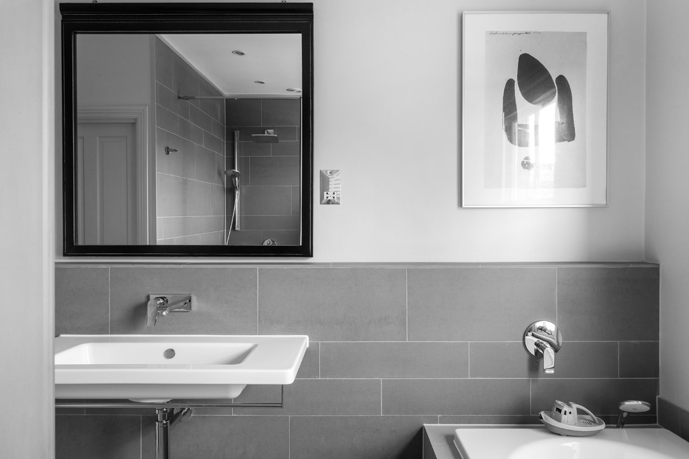 Design ideas for a small contemporary family bathroom in Surrey with a built-in bath, a walk-in shower, a one-piece toilet, grey tiles, ceramic tiles, grey walls, porcelain flooring, a console sink and tiled worktops.
