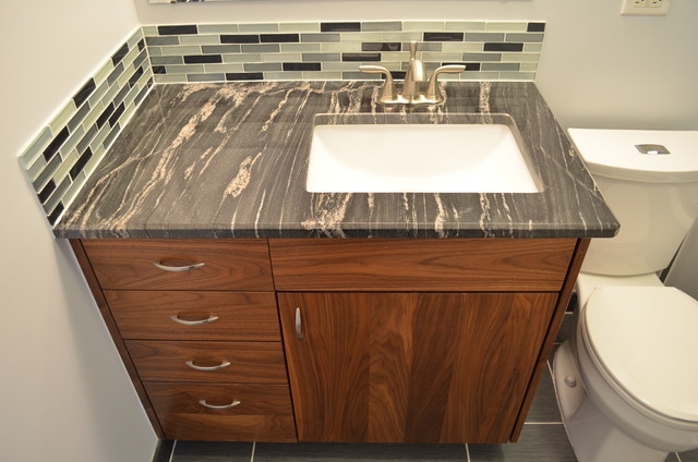 Example of a small trendy gray tile and porcelain tile porcelain tile and gray floor tub/shower combo design in Denver with flat-panel cabinets, dark wood cabinets, a one-piece toilet, blue walls, an undermount sink, granite countertops and an undermount tub