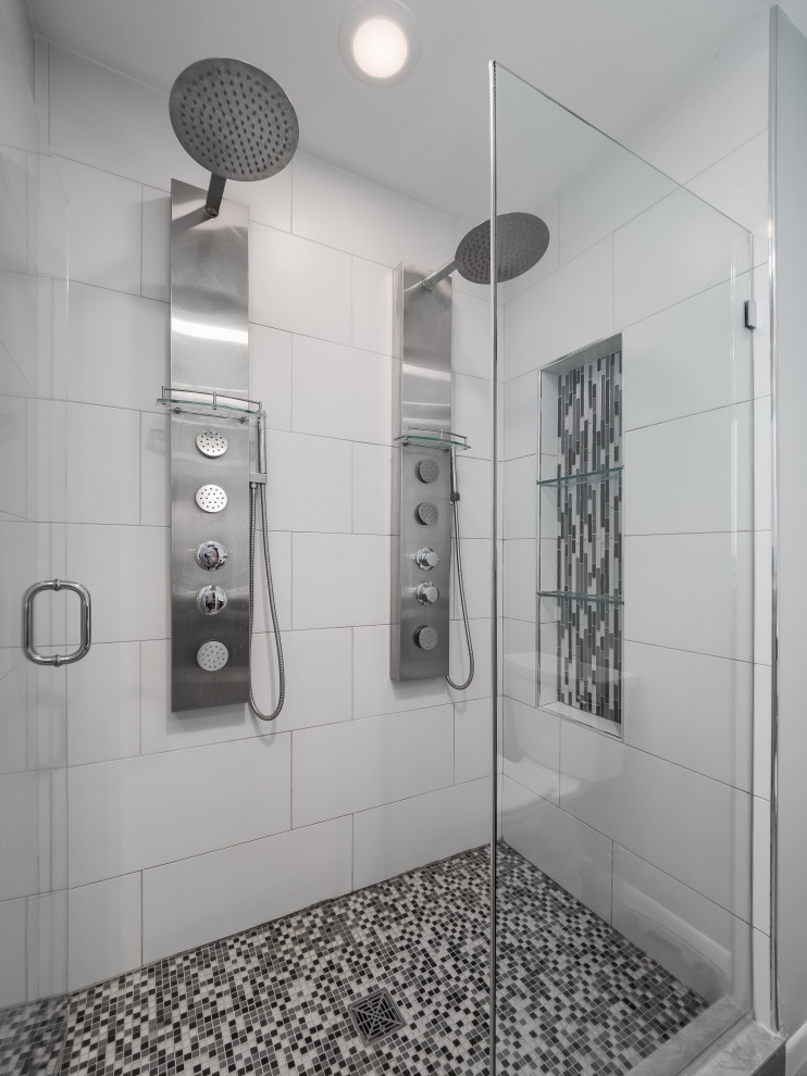 Inspiration for a mid-sized 1960s master white tile and ceramic tile beige floor and double-sink double shower remodel in Minneapolis with raised-panel cabinets, black cabinets, a one-piece toilet, white walls, a drop-in sink, marble countertops, a hinged shower door, beige countertops, a niche and a built-in vanity
