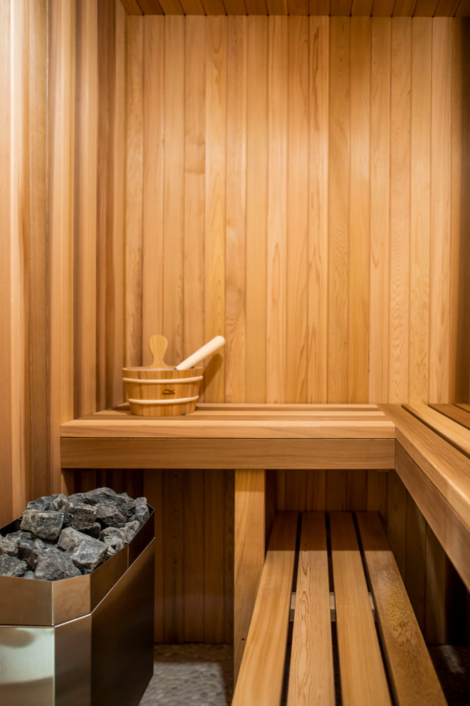 Photo of a medium sized contemporary sauna bathroom in Toronto with flat-panel cabinets, dark wood cabinets, an alcove shower, grey tiles, white tiles, porcelain tiles, grey walls, a built-in sink, solid surface worktops, a hinged door and white worktops.