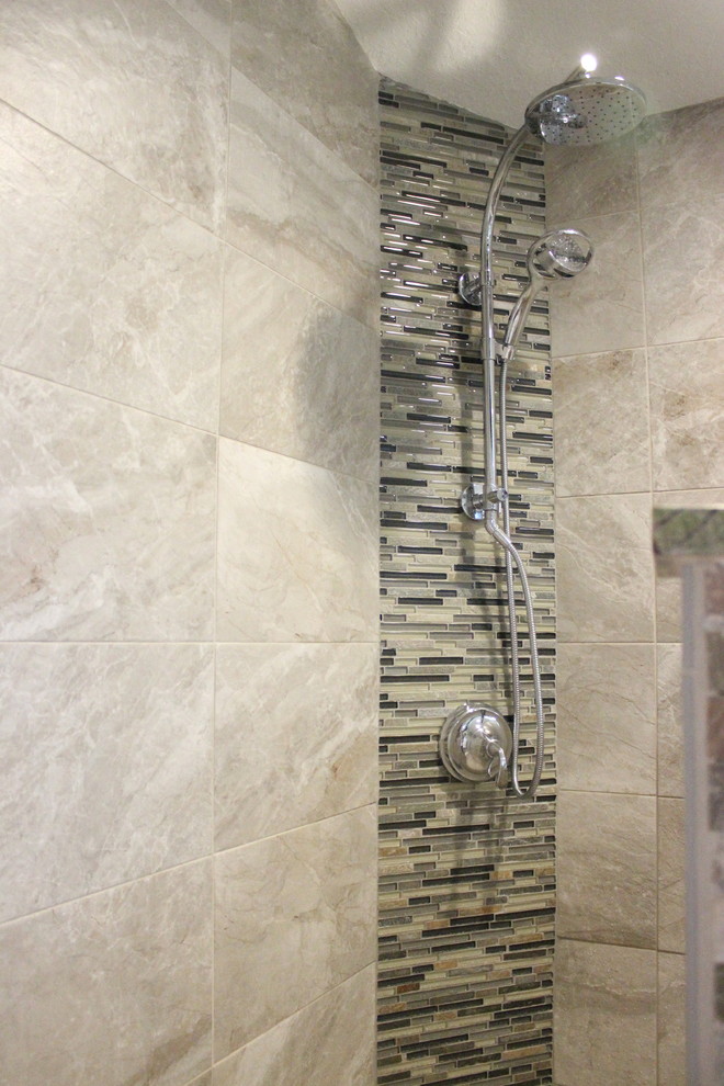 Photo of a large world-inspired ensuite bathroom in Tampa with flat-panel cabinets, dark wood cabinets, a freestanding bath, a corner shower, a two-piece toilet, beige tiles, brown tiles, grey tiles, multi-coloured tiles, stone tiles, grey walls, light hardwood flooring, a vessel sink and granite worktops.