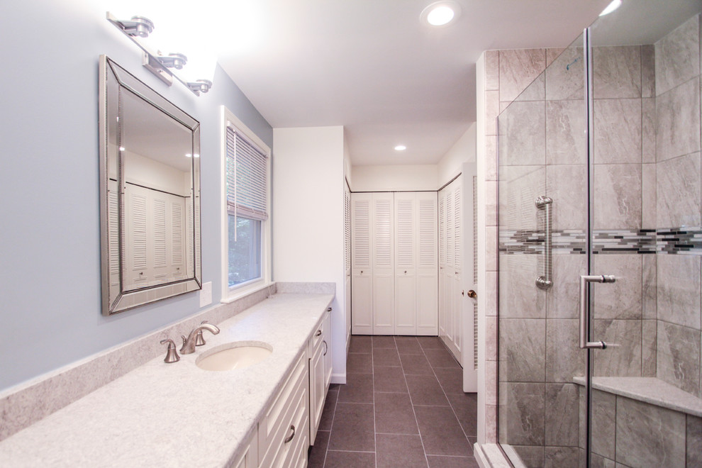 Inspiration for a huge timeless master gray tile and porcelain tile porcelain tile and gray floor alcove shower remodel in Philadelphia with recessed-panel cabinets, white cabinets, a two-piece toilet, blue walls, an undermount sink, quartzite countertops, a hinged shower door and gray countertops