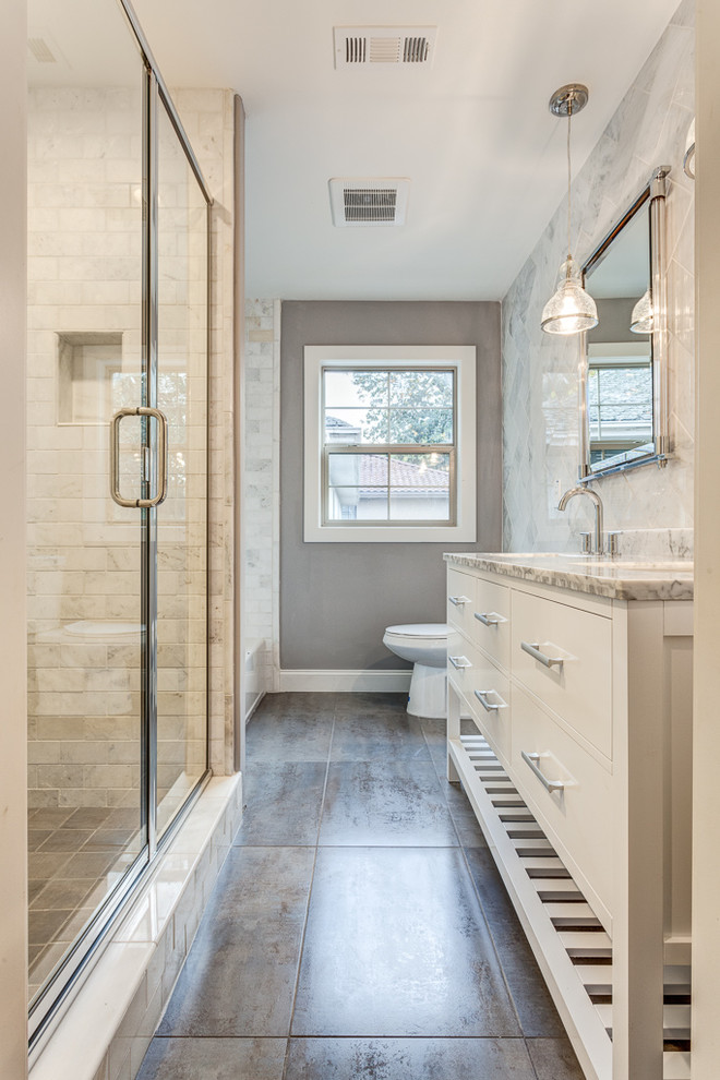 Example of a mid-sized classic white tile and stone tile ceramic tile bathroom design in Sacramento with an undermount sink, furniture-like cabinets, white cabinets, marble countertops, a two-piece toilet and gray walls