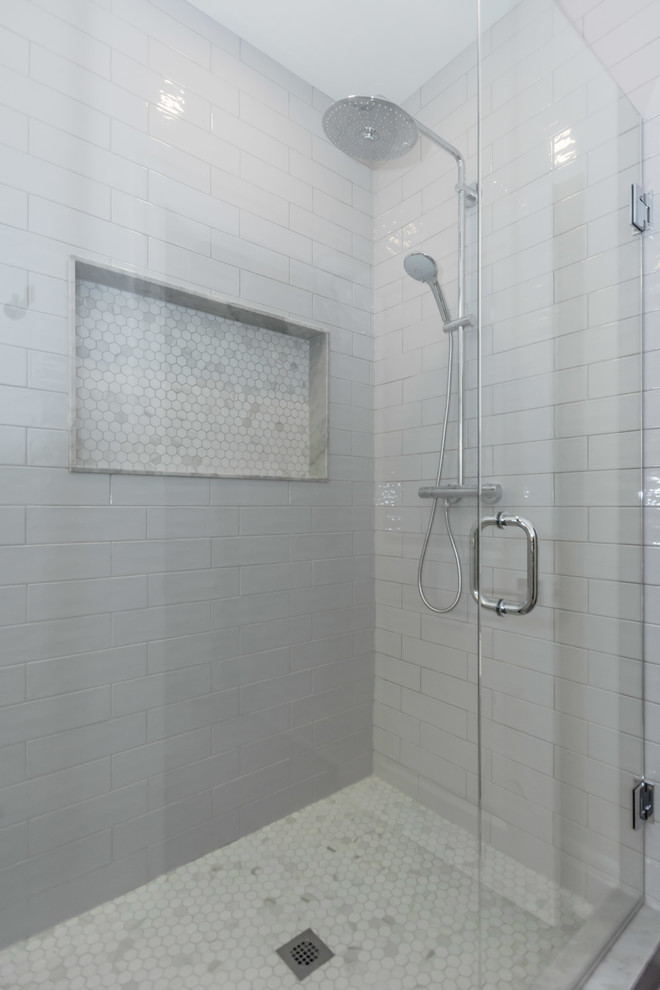 На фото: большая главная ванная комната в стиле неоклассика (современная классика) с отдельно стоящей ванной, угловым душем, серой плиткой, керамической плиткой, серыми стенами, полом из керамогранита, серым полом и душем с распашными дверями